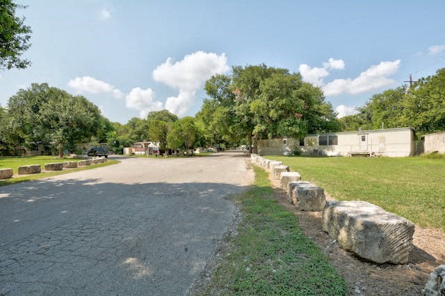 a parking lot with rocks on the side of a road