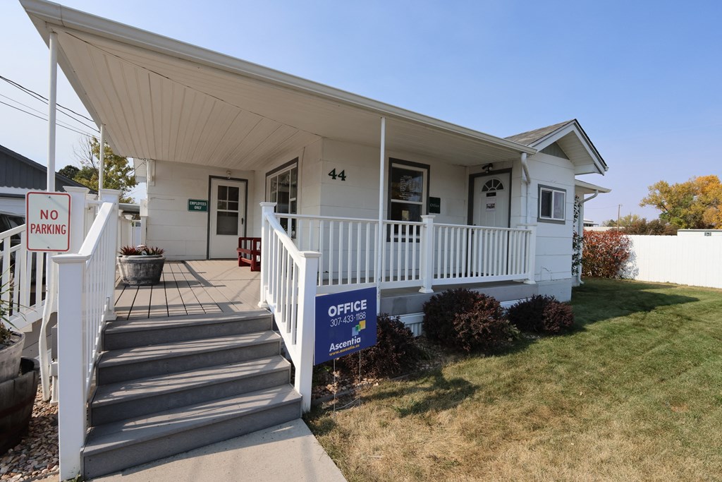 the front of a white house with a porch and a no parking sign at Country Lane, Cheyenne, WY
