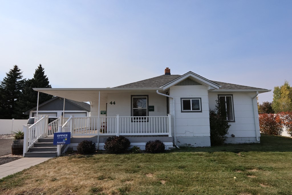 house with a porch and a lawn at Country Lane, Cheyenne, Wyoming