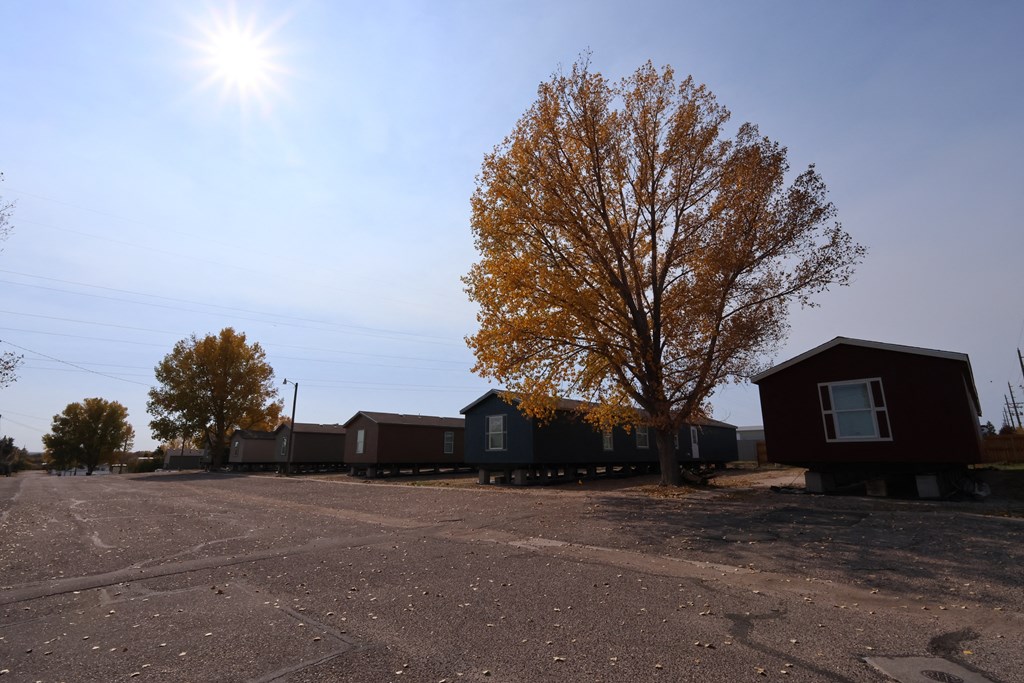 a row of small houses on the side of a road at Country Lane, Wyoming