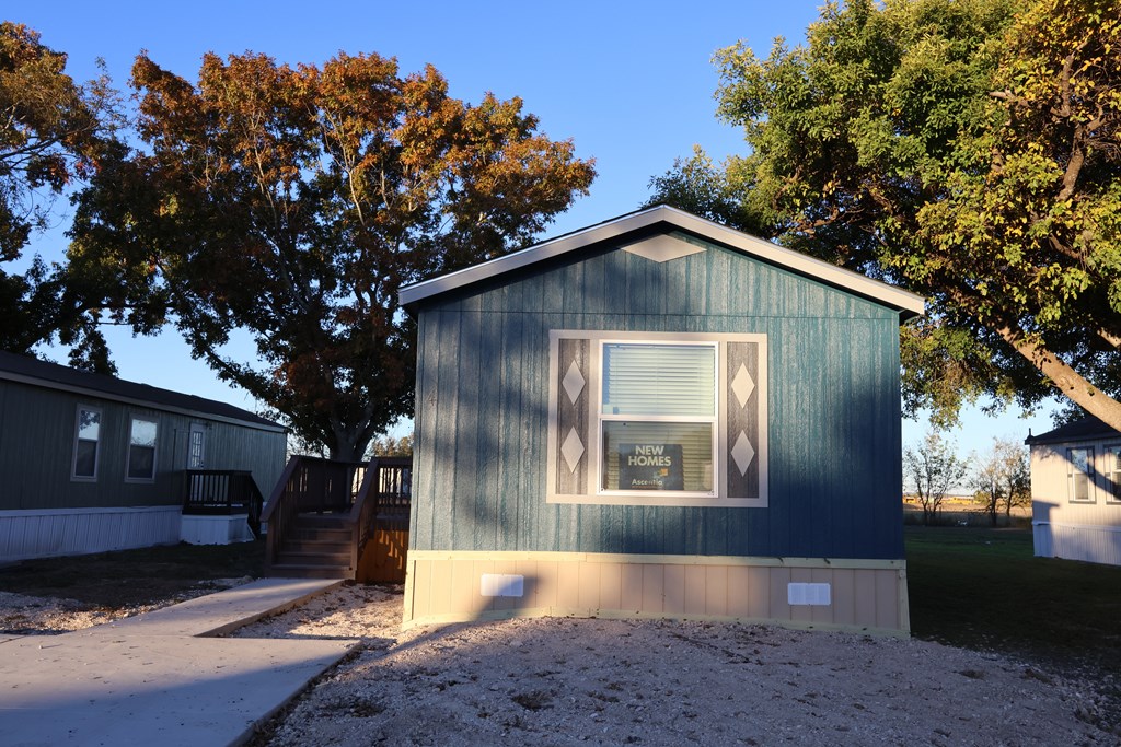 A small blue house with a white window and a brown door.