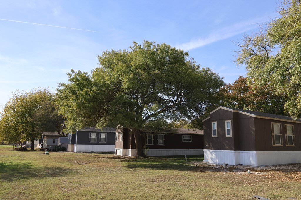 A row of houses with trees in the background.