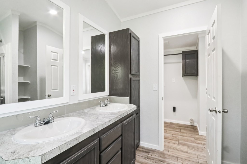 A bathroom with a white sink and a mirror above it.