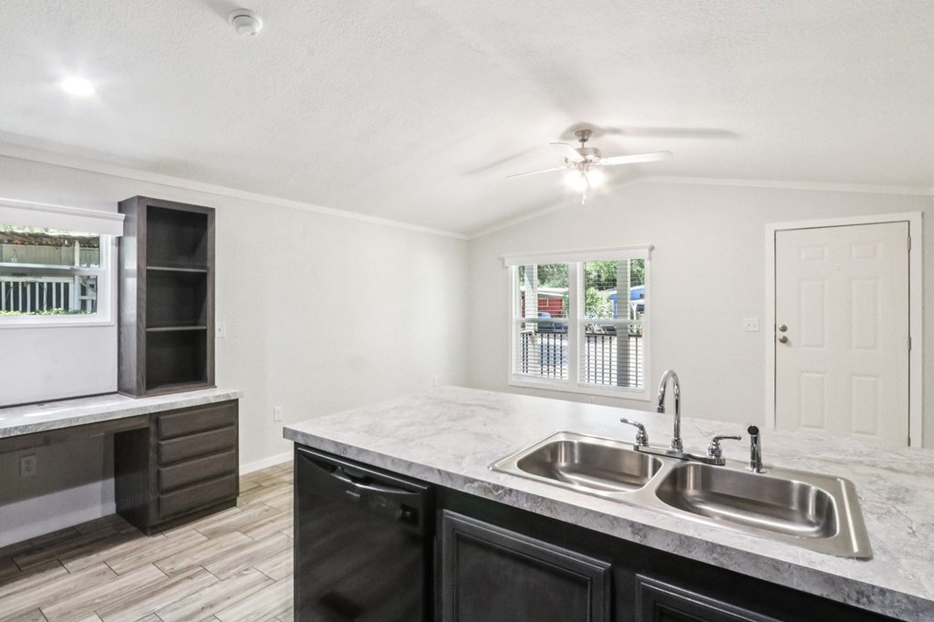 A kitchen with a sink and a refrigerator.