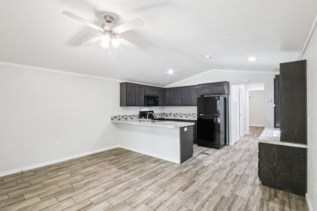 A modern kitchen with a fan on the ceiling.