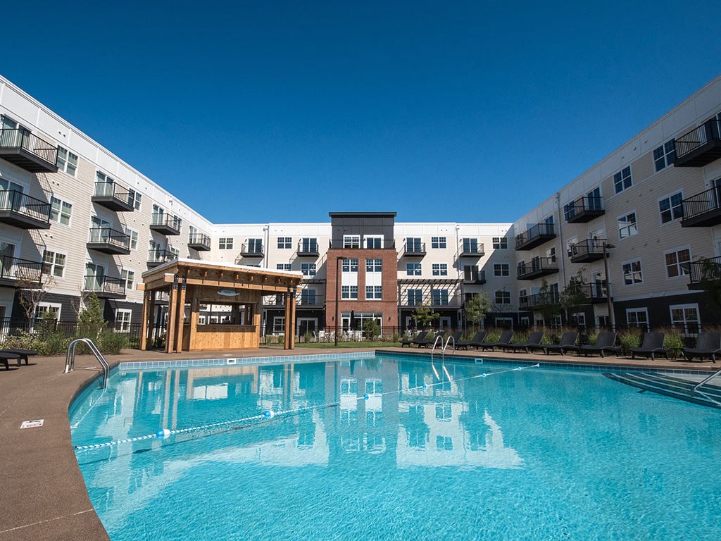 2-Bedroom Apartments in Lewis Center, OH - MIrada - Resort-Style Swimming Pool with Lounge Chairs, a Bar, and Maintained Landscaping 2-Bedroom Apartments in Lewis Center, OH - MIrada - Resort-Style Swimming Pool with Lounge Chairs, a Bar, and Maintained Landscaping