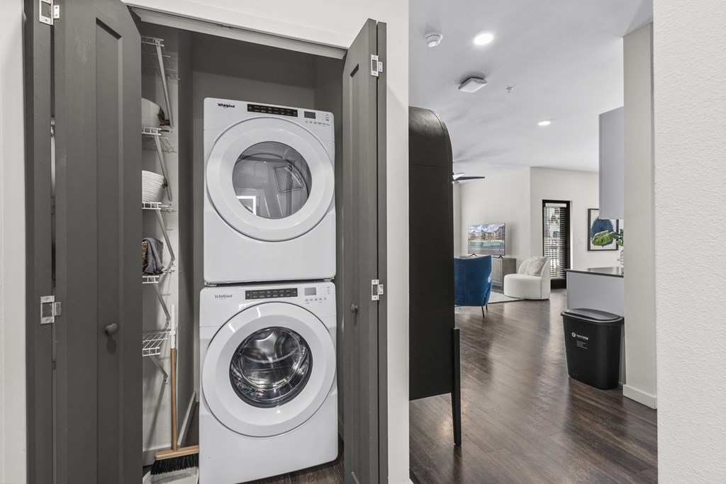 a washer and dryer in a closet in a living room