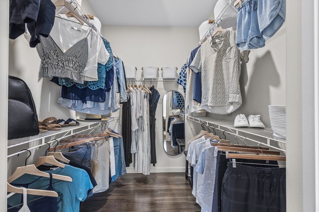 a closet with a lot of clothes hanging on a rack