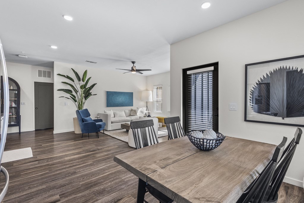 a living room and dining room with a wooden table