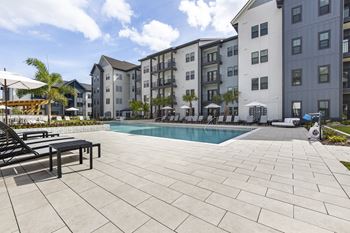 a swimming pool in front of an apartment building