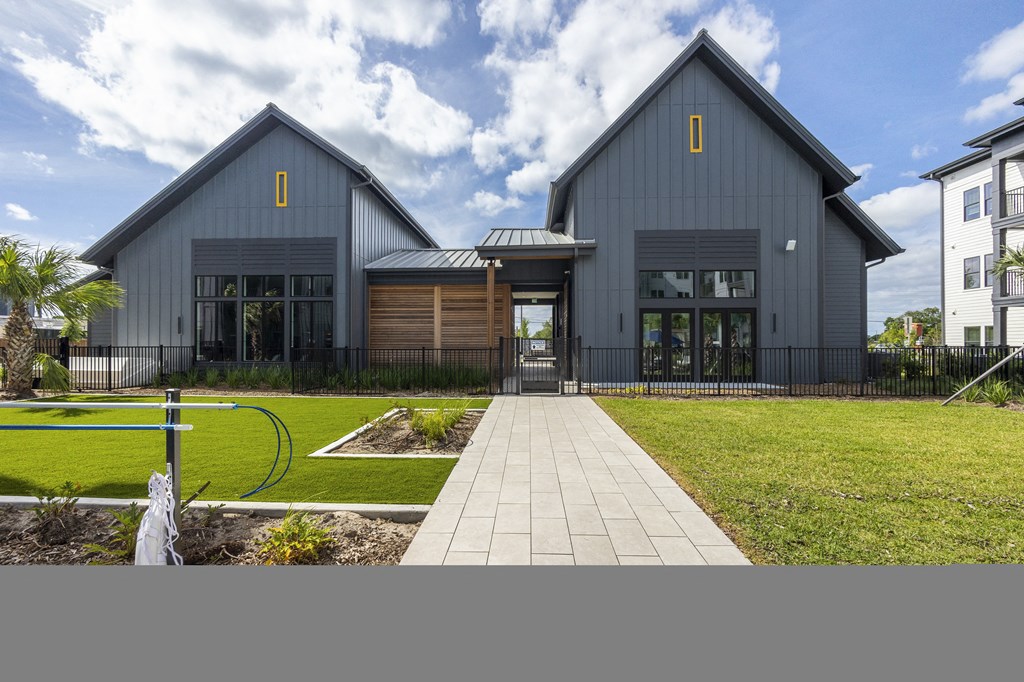 the exterior of a house with a walkway in front of it