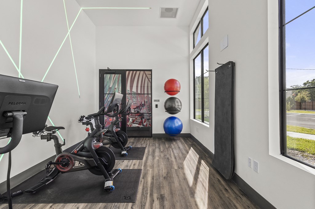 a home gym with exercise equipment and a window