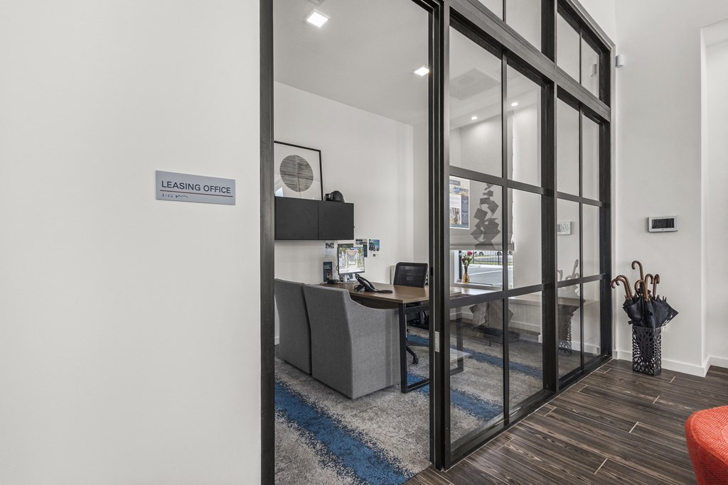 an office with a desk and a large glass door