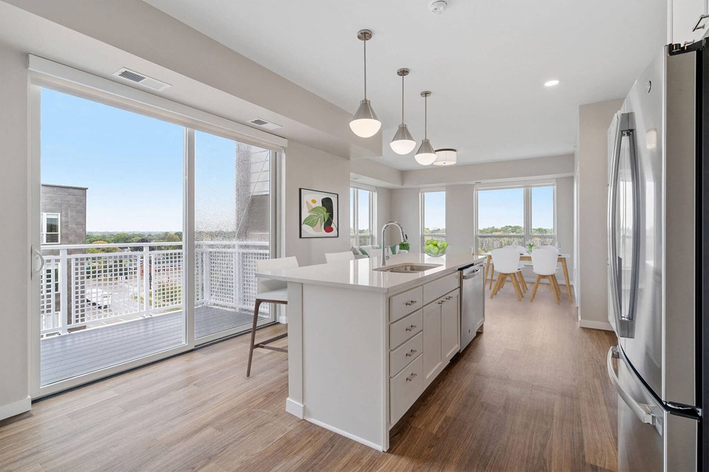 white kitchen with a large island at The Hallon Apartments, Hopkins, 55343