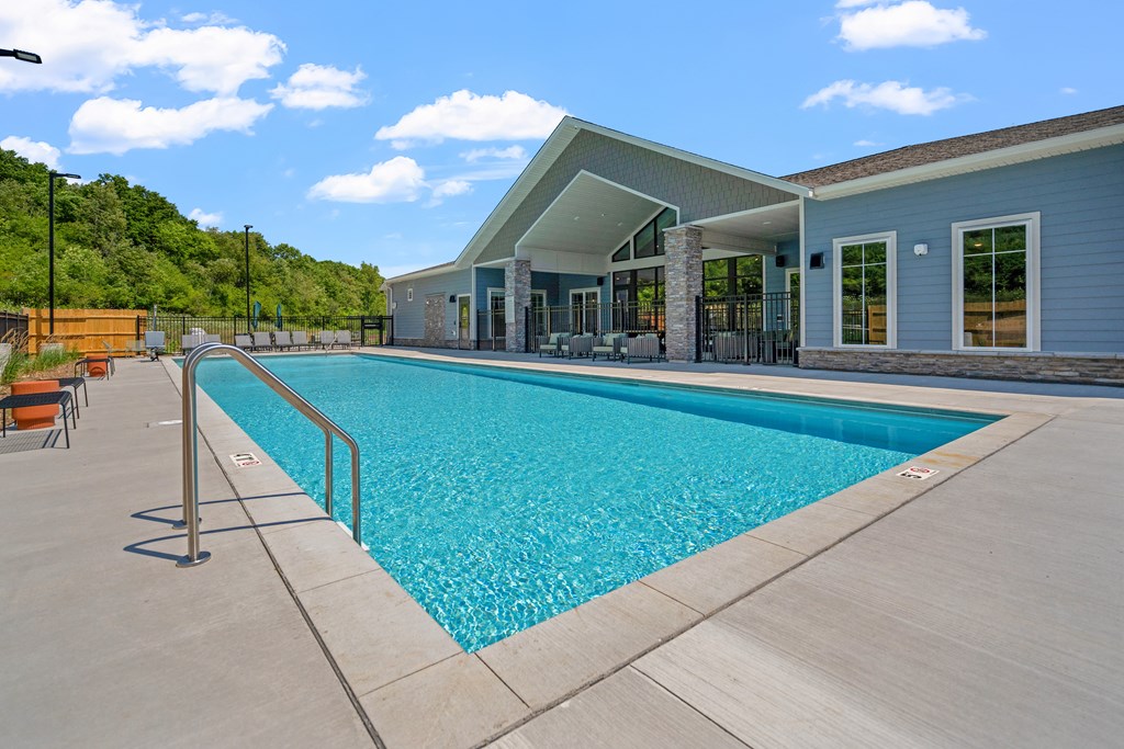 a swimming pool with a building in the background at The Lodge at Overland in Rochester Minnesota