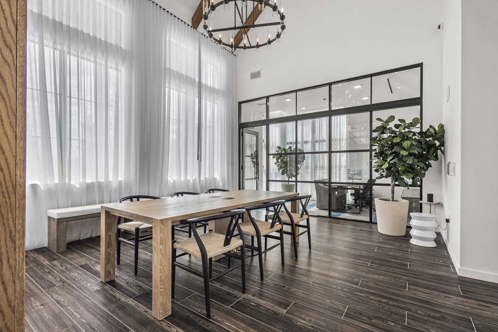 a dining room with a long wooden table and chairs