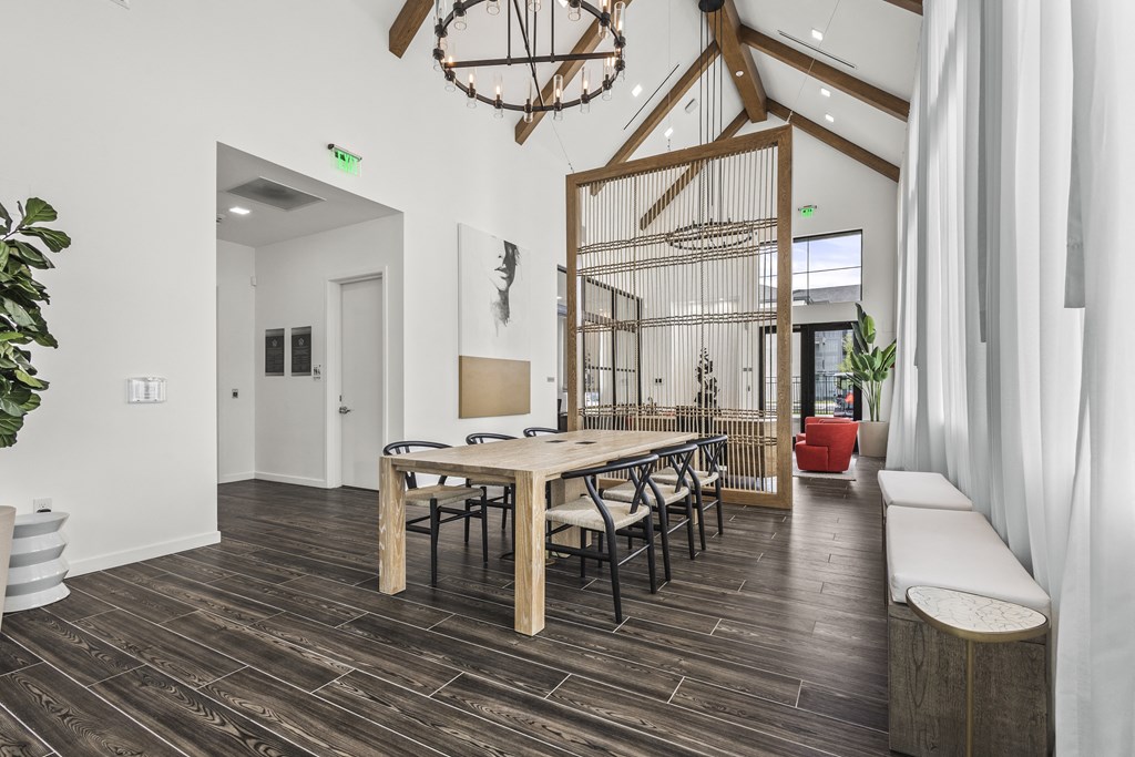 a dining room with a wooden table and chairs and a bird cage