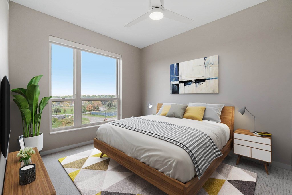 bedroom with queen bed and ample natural light at The Hallon Apartments, Hopkins, Minnesota