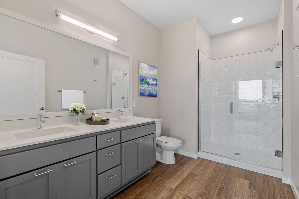 spacious modern bathroom with ample storage and spa shower at The Hallon Apartments, Minnesota