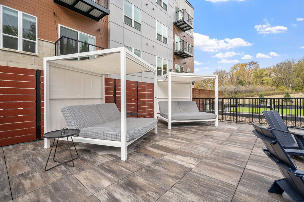 a patio with two chairs and a privacy wall at The Aurilla, Minnesota, 55016