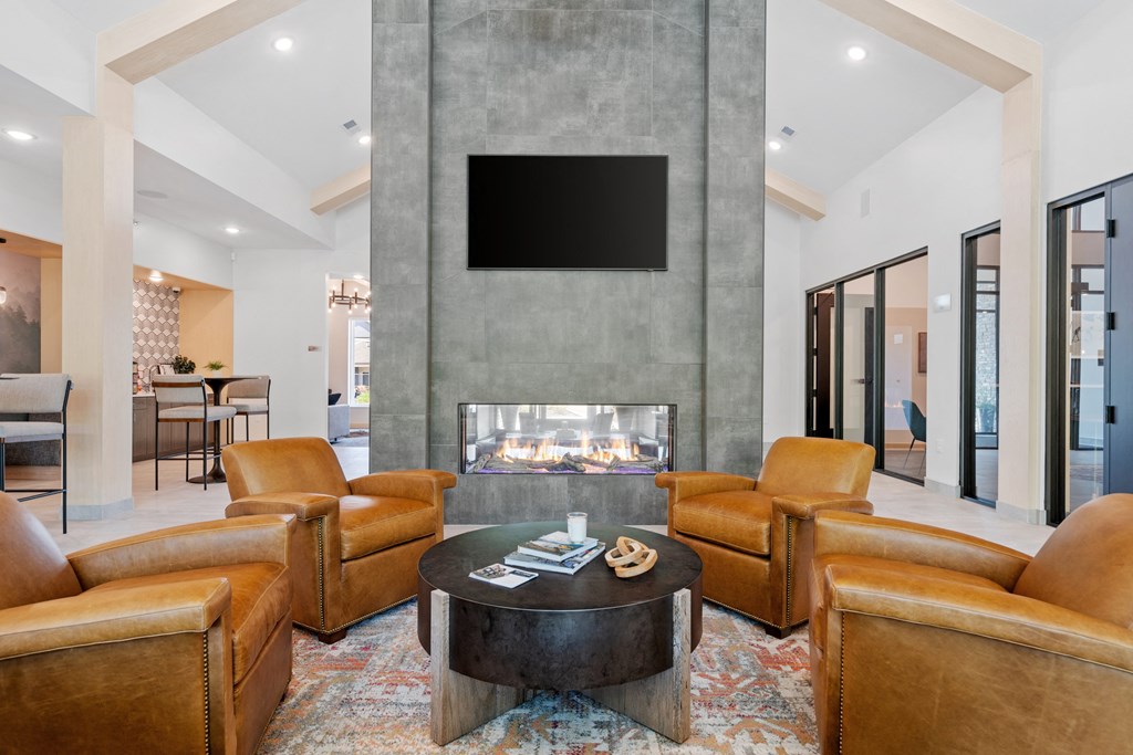a living room filled with furniture and a large fireplace at The Lodge at Overland, Rochester, Minnesota