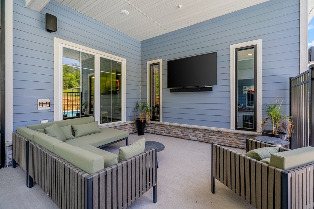 A covered patio with furniture and a flat screen tv at The Lodge at Overland, Rochester, Minnesota