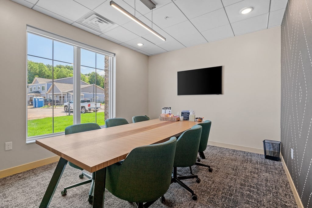 a conference room with a large window and a flat screen tv at The Lodge at Overland, Minnesota