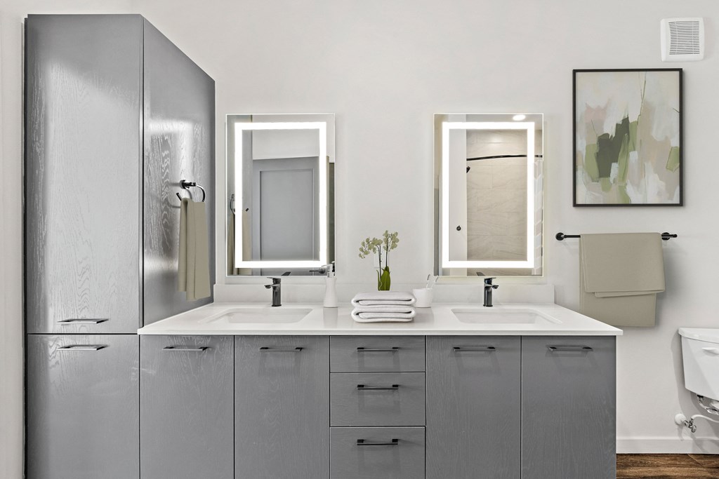 Double Vanity Bathroom with Gray Cabinets at Azalea Luxury Apartments Apartments
