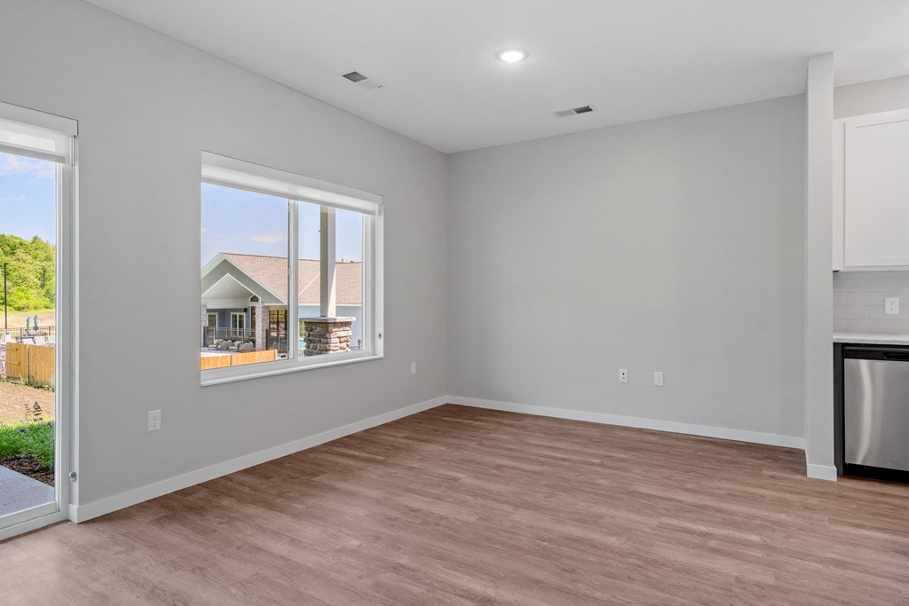 a bedroom with a large window and hardwood floors at The Lodge at Overland, Rochester, MN, 55901