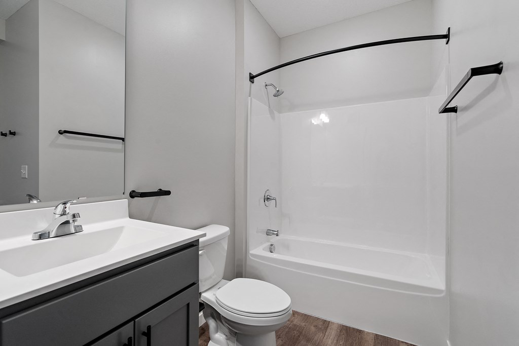 a bathroom with a bathtub toilet and sink at The Lodge at Overland, Minnesota