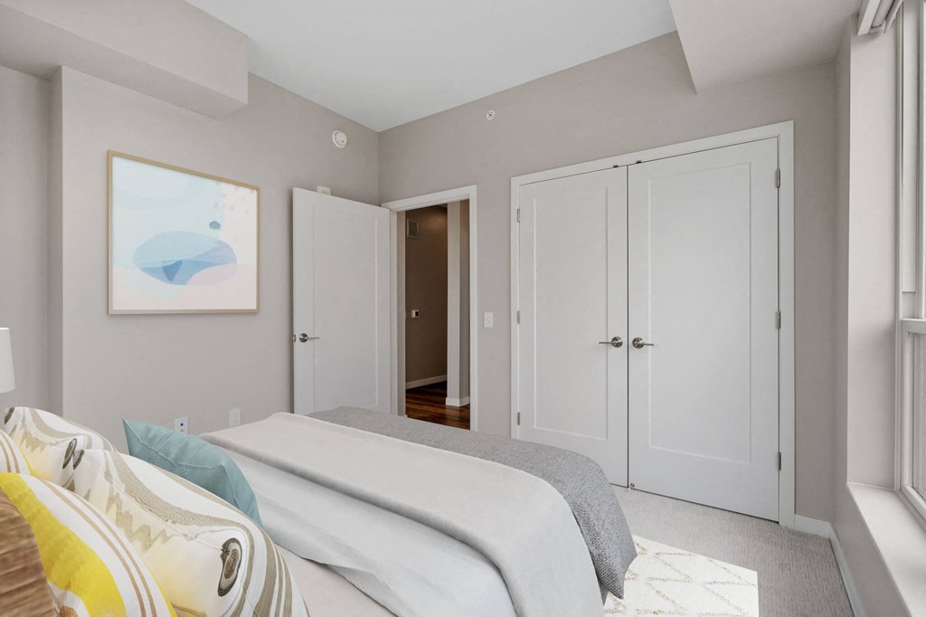 bedroom with French door closets at The Hallon Apartments, Hopkins,