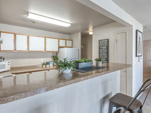 Kitchen with high top counter at The Villas at Bailey Ranch Apartments, Owasso, Oklahoma