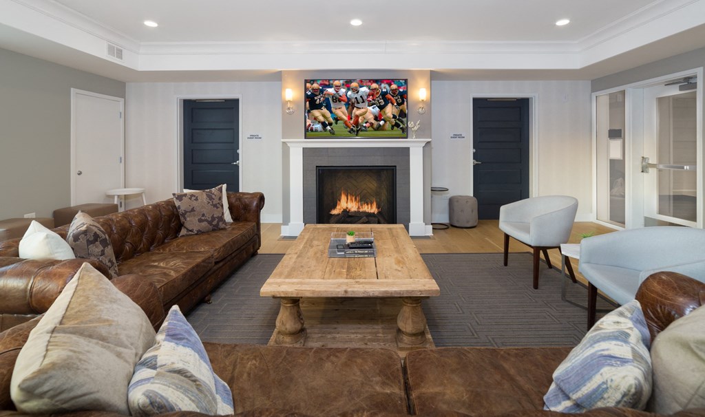 a living room with couches and a coffee table and a fireplace