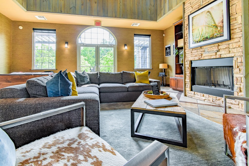 a living room with couches a coffee table and a fireplace  at Riverset Apartments, Tennessee, 38103