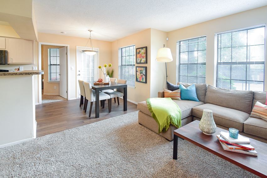 a living room with a couch and a table with chairs