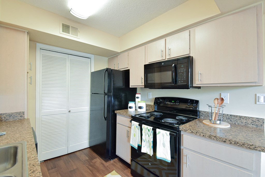 Kitchen with black appliances at Park Laureate Apartments, Louisville