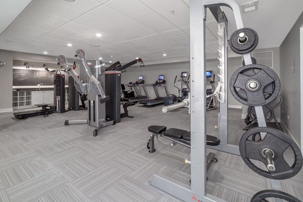 a gym with cardio machines and weights in aria on the avenue apartments