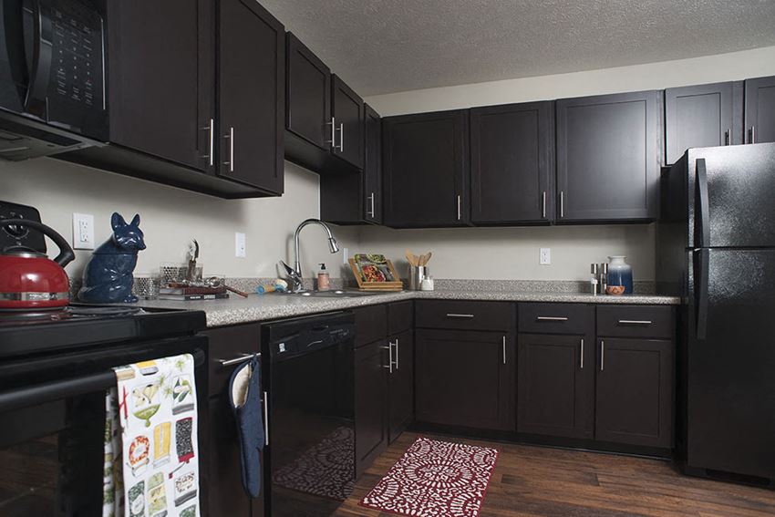 Kitchen with Black Appliances at The Pointe at St. Joseph Apartments, South Bend, Indiana - Photo Gallery 1