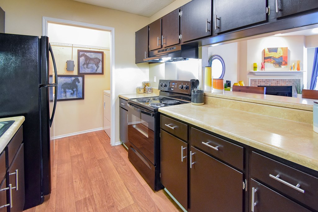 a kitchen with black cabinets and wood floors a kitchen with black cabinets and wood floors at Riverset Apartments, Memphis