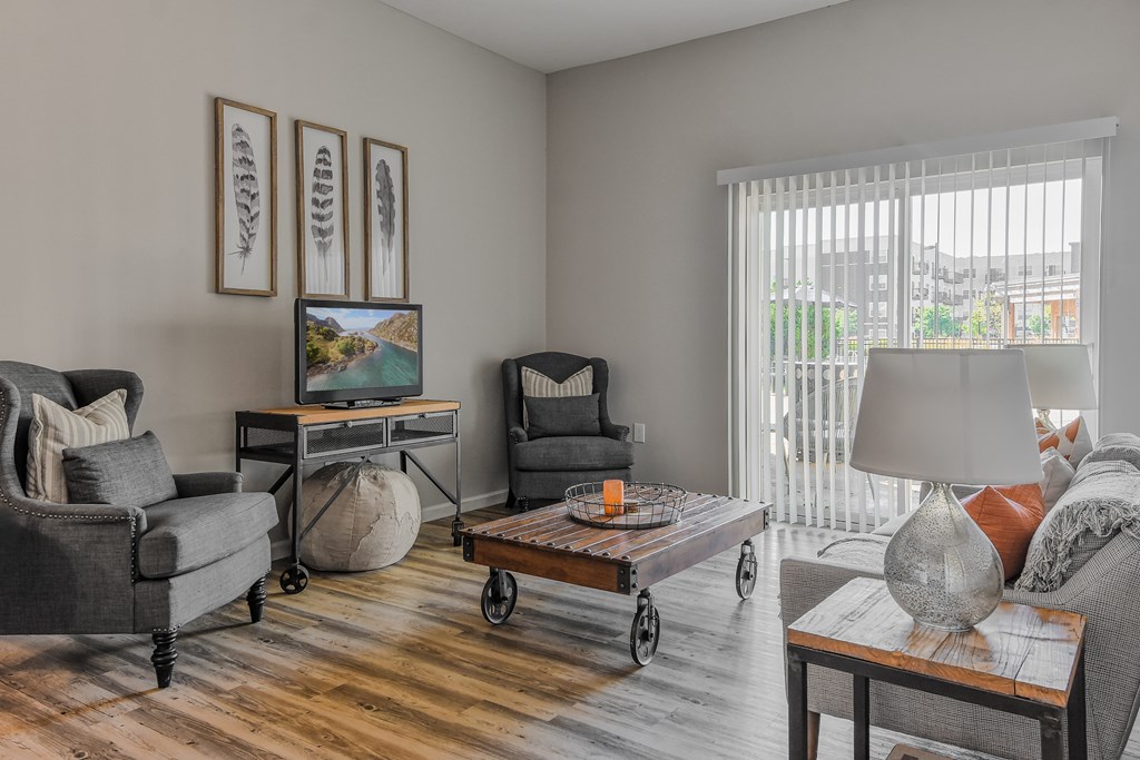 a living room with a couch and chairs and a table