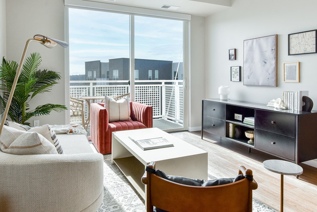 a living room with furniture and a large window at The Hallon Apartments, Minnesota, 55343