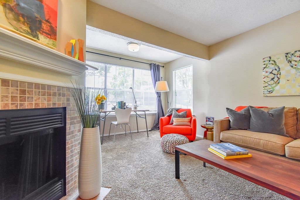 a living room with a fireplace and a large window  at Riverset Apartments, Memphis