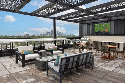 a rooftop patio with a tennis court and a view of the city