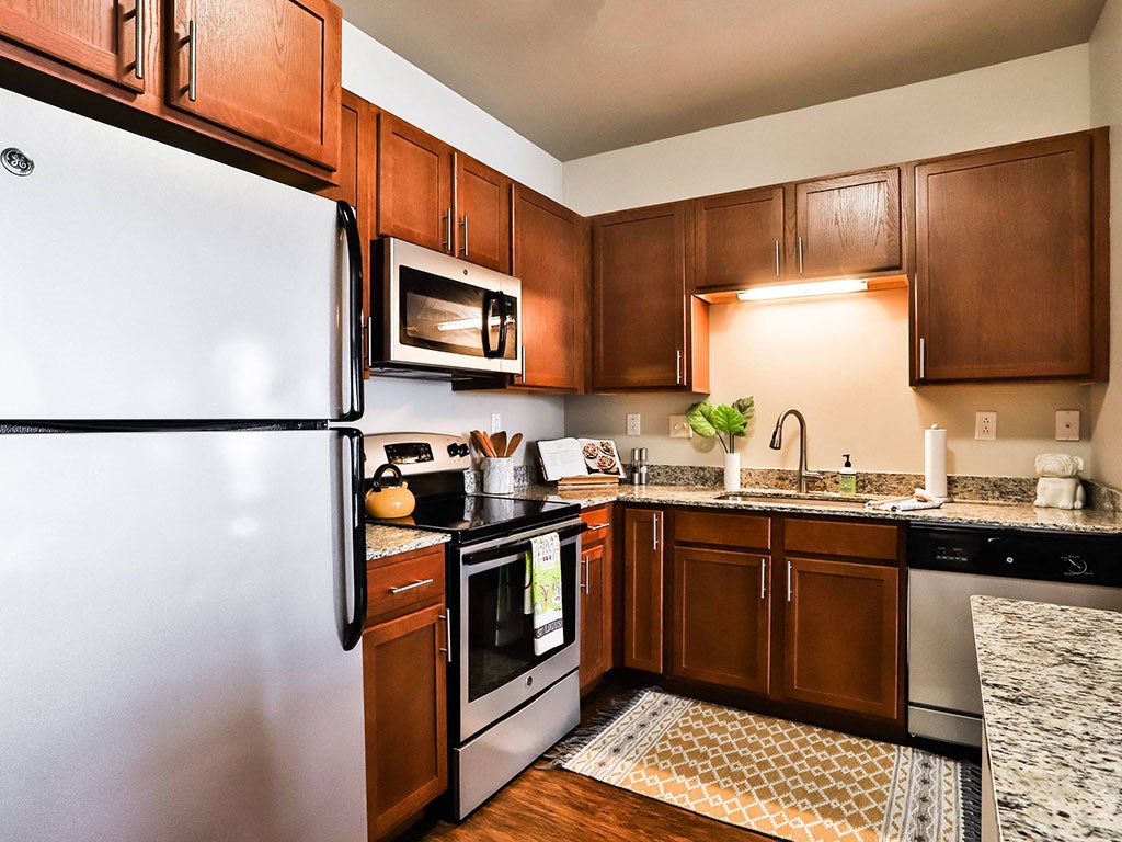 Kitchen with Fridge at Residences at The Streets of St. Charles Apartments in  St. Charles, Missouri