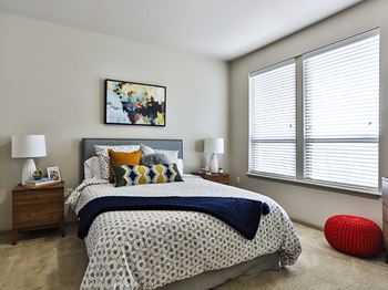 Bedroom with bed at Residences at The Streets of St. Charles Apartments in St. Charles