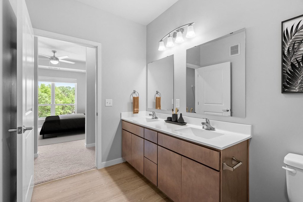 a bathroom with a large mirror and a sink at The Aurilla, Minnesota, 55016