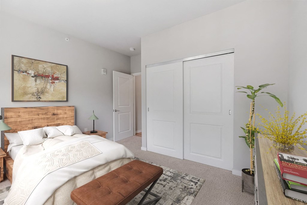a bedroom with white walls and a bed with a wooden headboard at The Aurilla, Minnesota, 55016