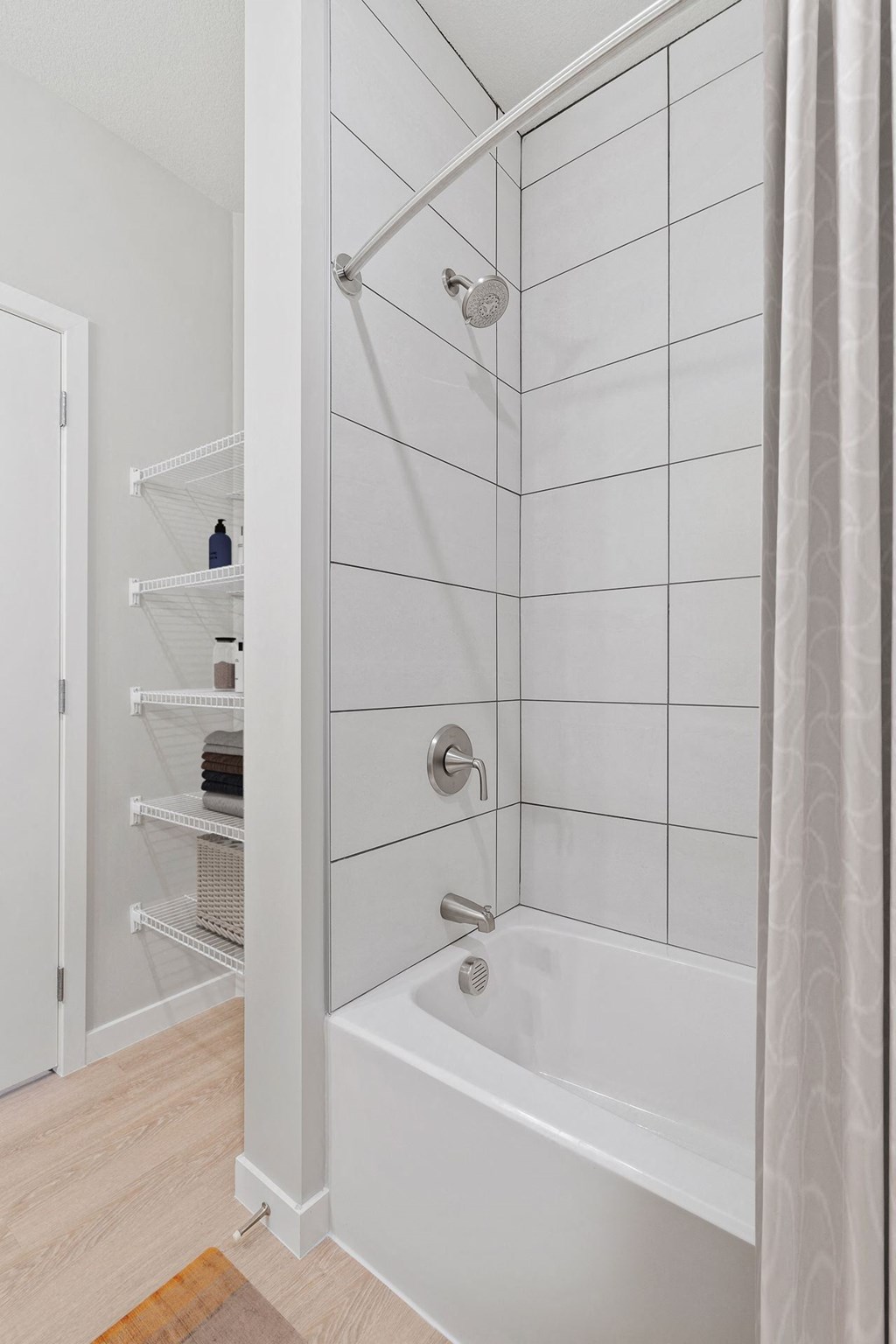 a white bathroom with a shower and a shower curtain at The Aurilla, Cottage Grove, Minnesota
