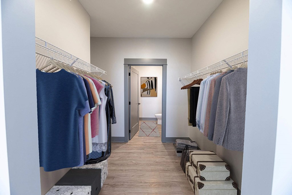 Large walk-in closet with attached bathroom at The Commons at Rivertown, Grandville, 49418