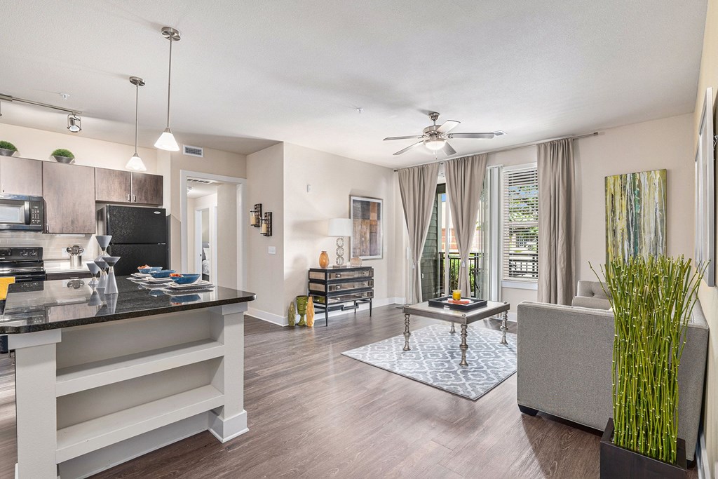 A modern kitchen with a black countertop and a large island.